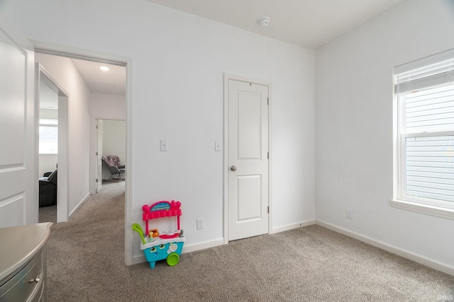 game room with carpet floors, healthy amount of natural light, and baseboards