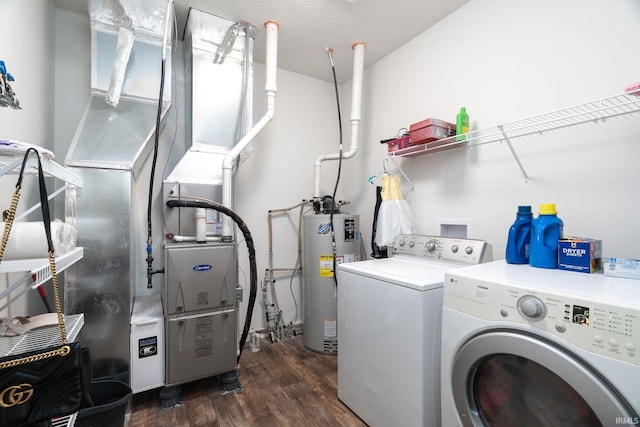 laundry area with water heater, separate washer and dryer, and dark wood-style flooring