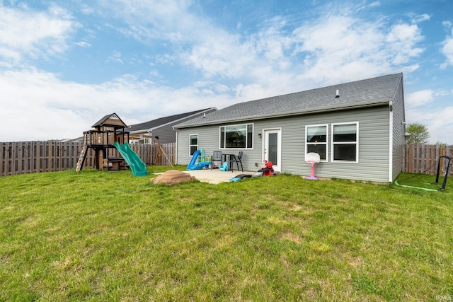 back of property with a playground and a patio area