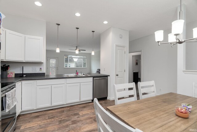 kitchen with appliances with stainless steel finishes, a ceiling fan, dark wood-style floors, dark countertops, and white cabinets
