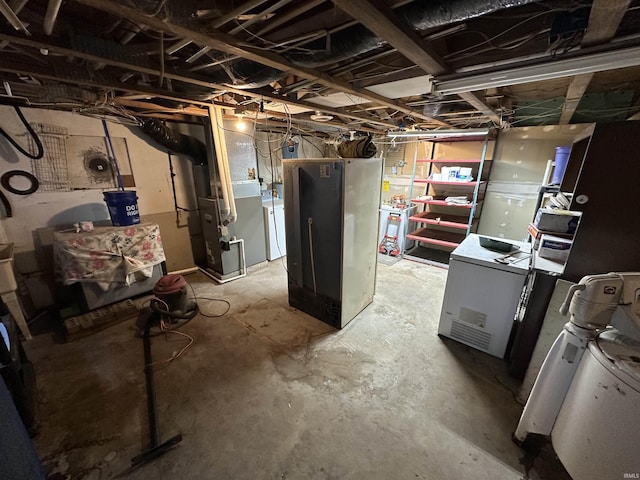 15850-2 Witt Rd, Shoals, IN 47581 - unfinished basement with washer / clothes dryer, heating unit, and fridge