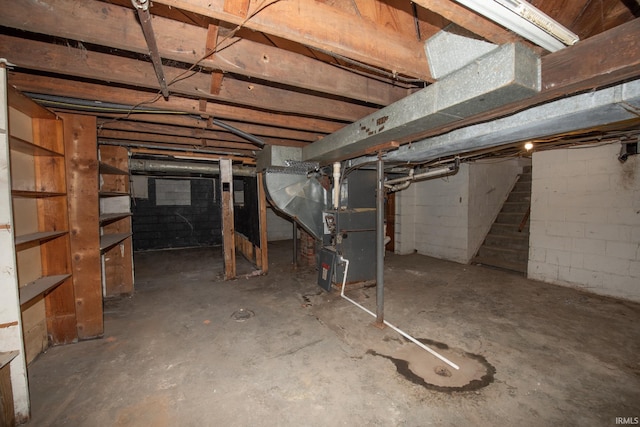 unfinished basement featuring heating unit