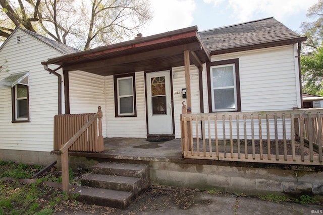 view of front of house featuring a shingled roof and covered porch