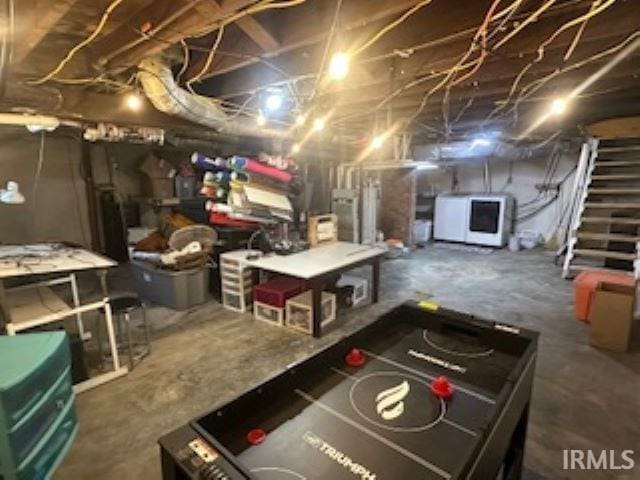 playroom featuring concrete flooring and washer and clothes dryer
