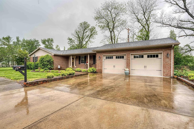 ranch-style house featuring brick siding, concrete driveway, an attached garage, and a front yard