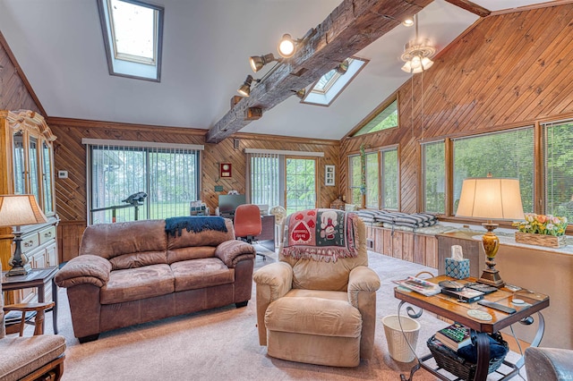 living room with a skylight, wooden walls, carpet, high vaulted ceiling, and beamed ceiling