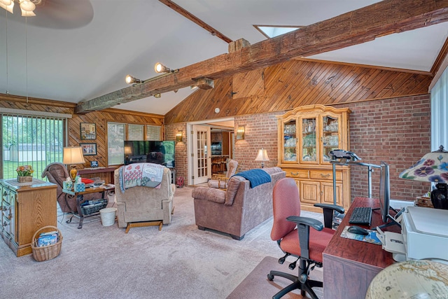 living area with carpet, wood walls, brick wall, ceiling fan, and an office area