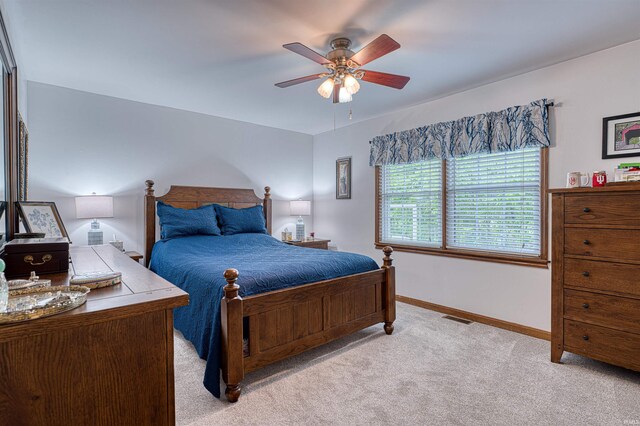 carpeted bedroom with baseboards and ceiling fan