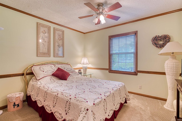 bedroom with carpet, a textured ceiling, ceiling fan, crown molding, and baseboards