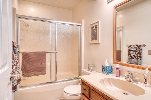 bathroom with vanity, toilet, and enclosed tub / shower combo