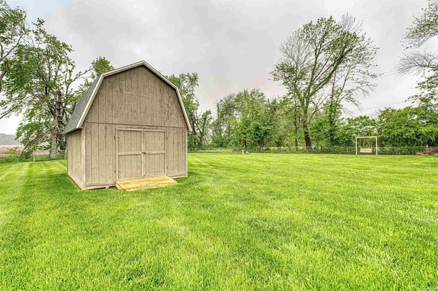 view of grassy yard featuring an outbuilding and a storage shed