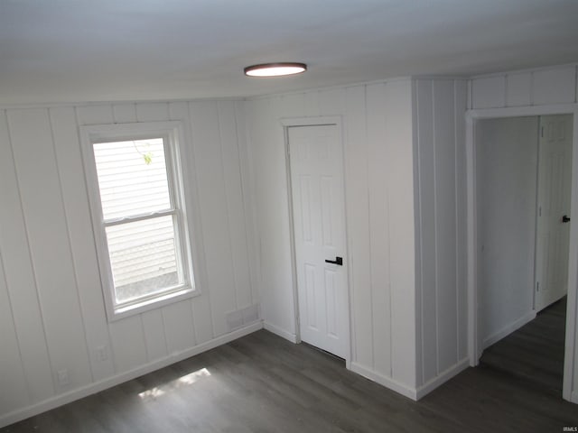1252 Fremont St, South Bend, IN 46628 - unfurnished room with dark wood-type flooring, baseboards, and a decorative wall