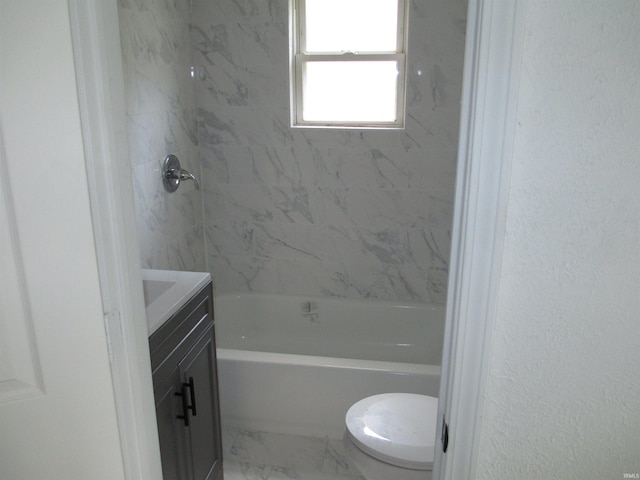 1252 Fremont St, South Bend, IN 46628 - full bath featuring marble look tile flooring, vanity, toilet, and tub / shower combination