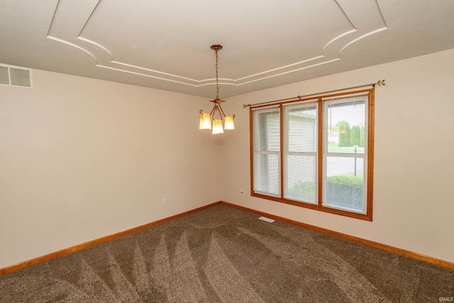 spare room featuring dark colored carpet and baseboards