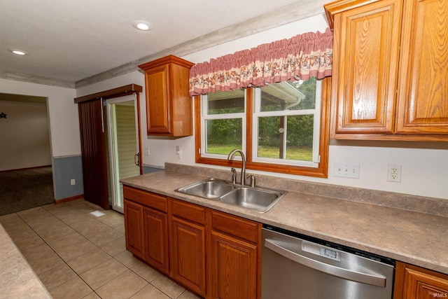 kitchen with stainless steel dishwasher, a sink, light tile patterned floors, brown cabinets, and recessed lighting
