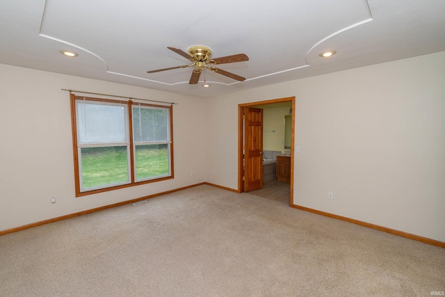 spare room featuring attic access, light colored carpet, recessed lighting, baseboards, and ceiling fan