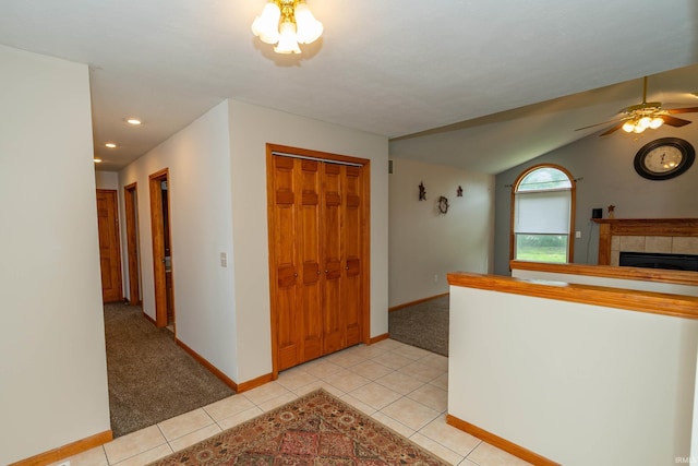 entryway featuring baseboards, ceiling fan, a tile fireplace, light tile patterned floors, and recessed lighting