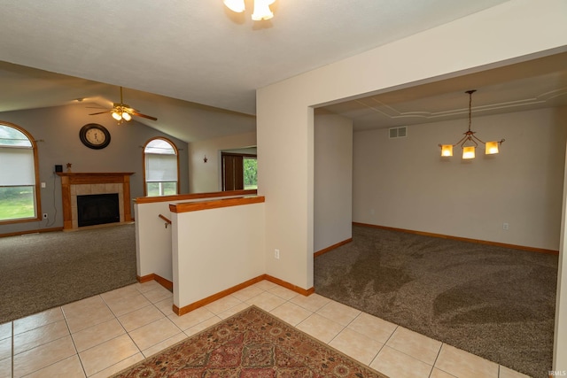 unfurnished room with light colored carpet, healthy amount of natural light, baseboards, and lofted ceiling