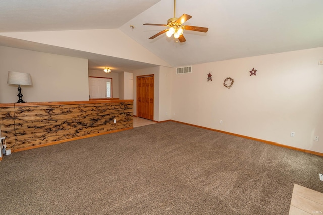 unfurnished room with ceiling fan, vaulted ceiling, light colored carpet, and baseboards