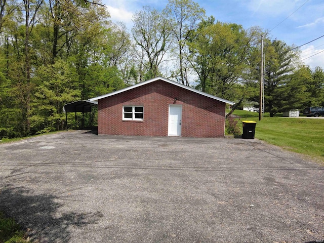 4702 N 37th Hwy, Bedford, IN 47421 - view of side of property with driveway, a carport, a yard, and brick siding