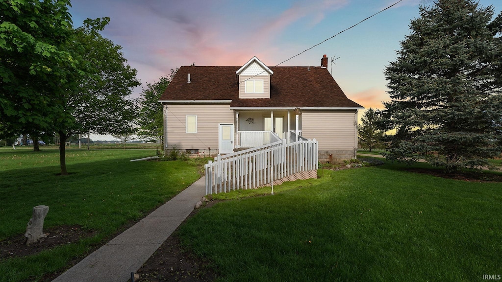 2285 S Salem Rd, Monroe, IN 46772 - back of property at dusk featuring a lawn, covered porch, a chimney, and roof with shingles