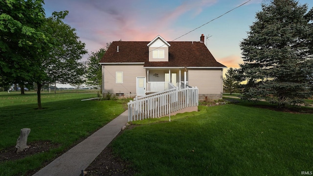 2285 S Salem Rd, Monroe, IN 46772 - back of property at dusk featuring a lawn, covered porch, a chimney, and roof with shingles