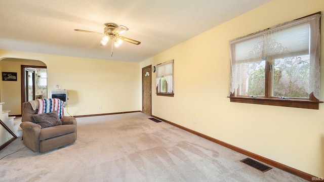 2285 S Salem Rd, Monroe, IN 46772 - sitting room with arched walkways, a ceiling fan, light colored carpet, and baseboards
