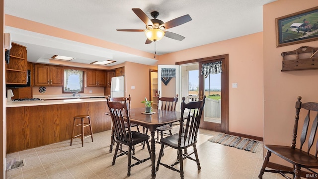 2285 S Salem Rd, Monroe, IN 46772 - dining space featuring light floors, a ceiling fan, and baseboards