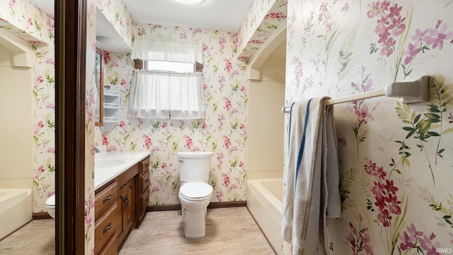 2285 S Salem Rd, Monroe, IN 46772 - bathroom featuring toilet, wallpapered walls, wood finished floors, vanity, and baseboards