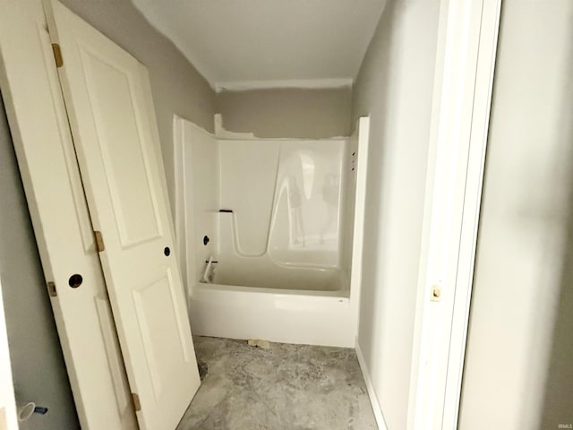 full bath with washtub / shower combination and unfinished concrete floors