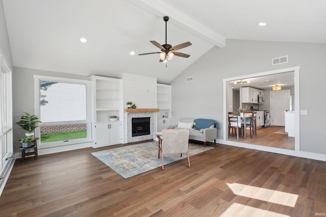 5363 W Warren Ave, Silver Lake, IN 46982 - living room featuring ceiling fan, beam ceiling, a fireplace, wood finished floors, and high vaulted ceiling