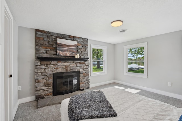 5363 W Warren Ave, Silver Lake, IN 46982 - living area with carpet floors, a fireplace, baseboards, and a water view