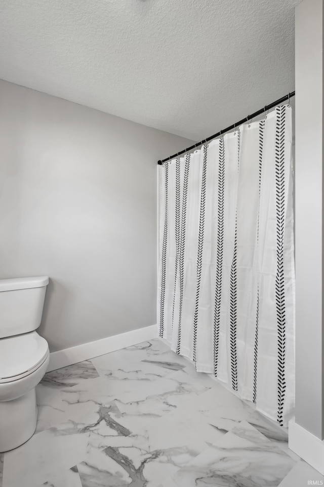 5363 W Warren Ave, Silver Lake, IN 46982 - bathroom featuring toilet, baseboards, a textured ceiling, and marble finish floors