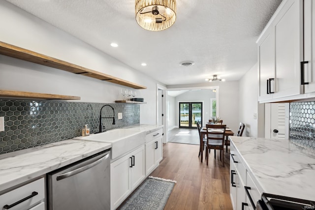 5363 W Warren Ave, Silver Lake, IN 46982 - kitchen with open shelves, stainless steel dishwasher, a sink, decorative backsplash, and light wood-type flooring
