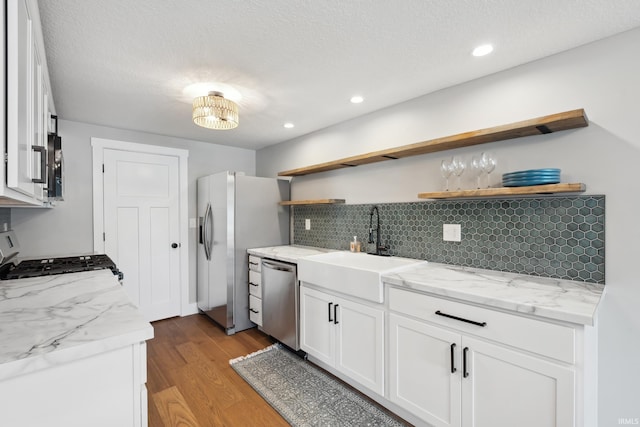 5363 W Warren Ave, Silver Lake, IN 46982 - kitchen with stainless steel appliances, a sink, open shelves, backsplash, and light wood-style flooring