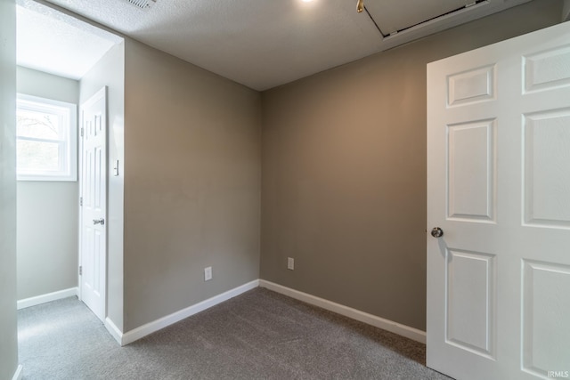 spare room with baseboards and carpet floors