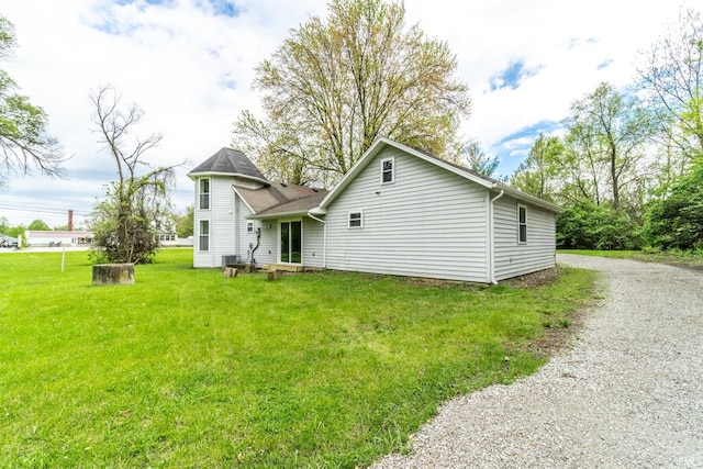 back of house with a lawn and driveway