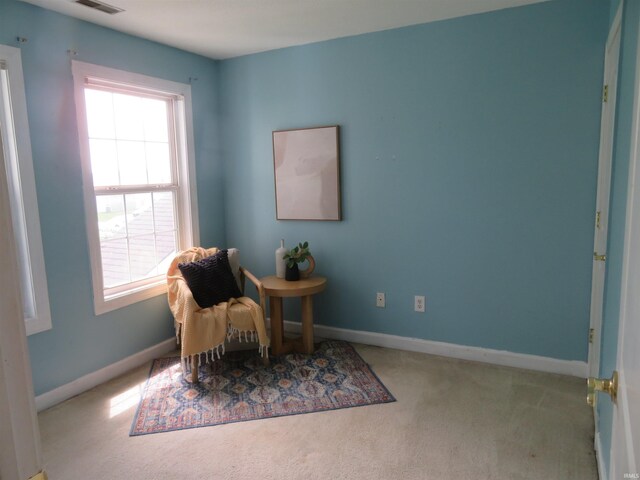sitting room featuring carpet floors and baseboards