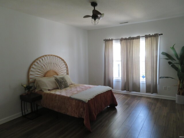 bedroom featuring wood finished floors and baseboards