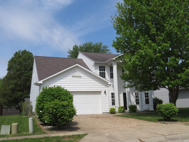 view of front of property featuring concrete driveway and an attached garage