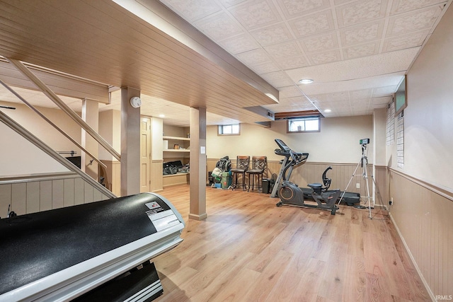 exercise area with wood finished floors and wainscoting