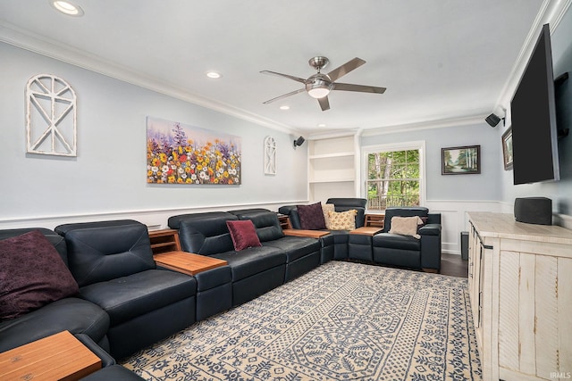 living room featuring ornamental molding, a ceiling fan, wainscoting, and recessed lighting