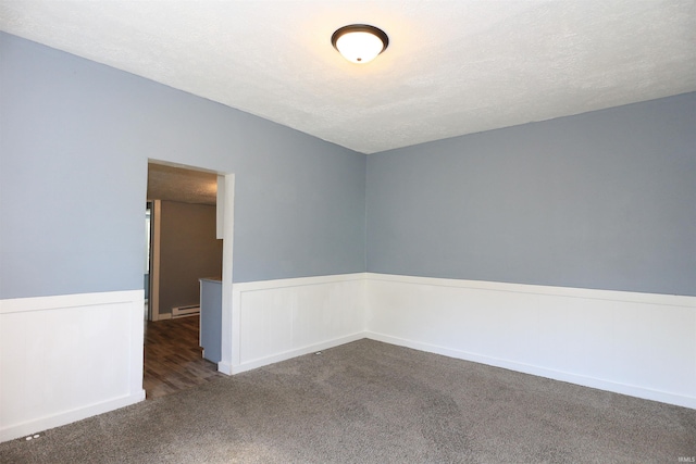 455 E Barner St, Frankfort, IN 46041 - spare room with carpet flooring, a wainscoted wall, a baseboard radiator, and a textured ceiling
