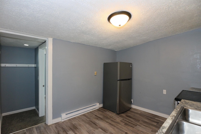 455 E Barner St, Frankfort, IN 46041 - kitchen featuring freestanding refrigerator, baseboard heating, dark wood-type flooring, a textured ceiling, and a sink