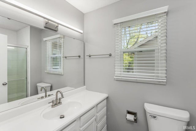 full bath with toilet, a shower with door, and vanity