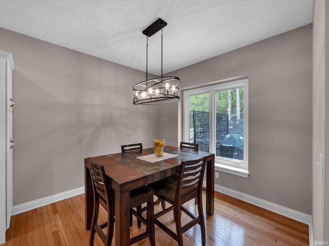 1745 Mill Pond Ln, Lafayette, IN 47905 - dining space featuring baseboards, light wood-style floors, and a chandelier