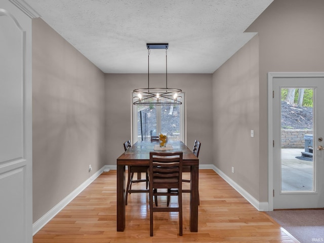 1745 Mill Pond Ln, Lafayette, IN 47905 - dining area with light wood-type flooring, a chandelier, baseboards, and a textured ceiling