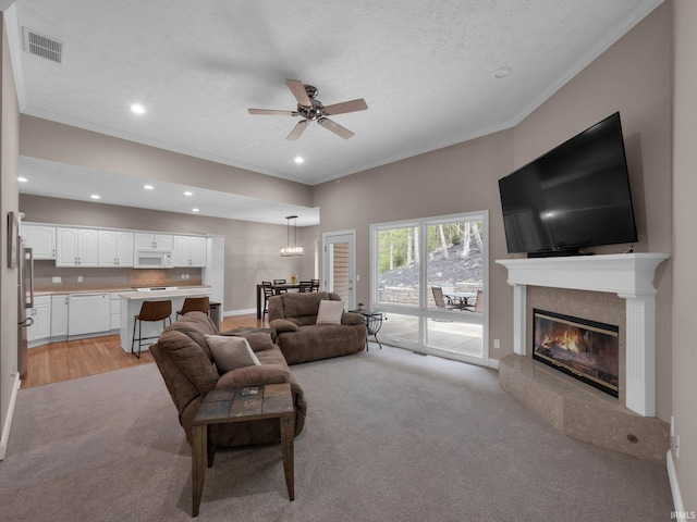 1745 Mill Pond Ln, Lafayette, IN 47905 - living room with light colored carpet, ornamental molding, ceiling fan, a tile fireplace, and recessed lighting