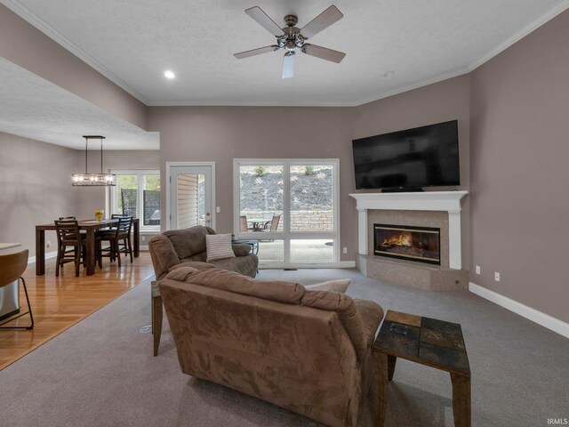 1745 Mill Pond Ln, Lafayette, IN 47905 - living room with a textured ceiling, crown molding, a glass covered fireplace, ceiling fan, and baseboards