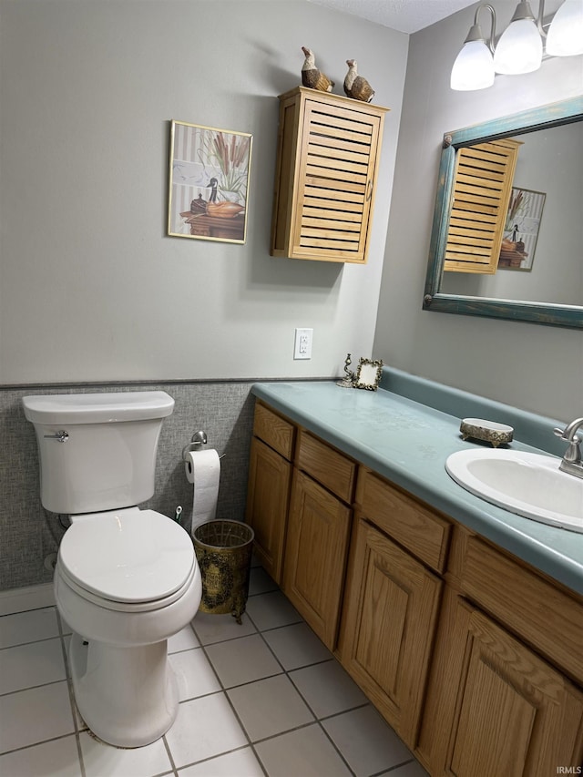9607 S Lake Ridge Dr, Bloomington, IN 47401 - bathroom with toilet, wainscoting, tile patterned floors, vanity, and tile walls